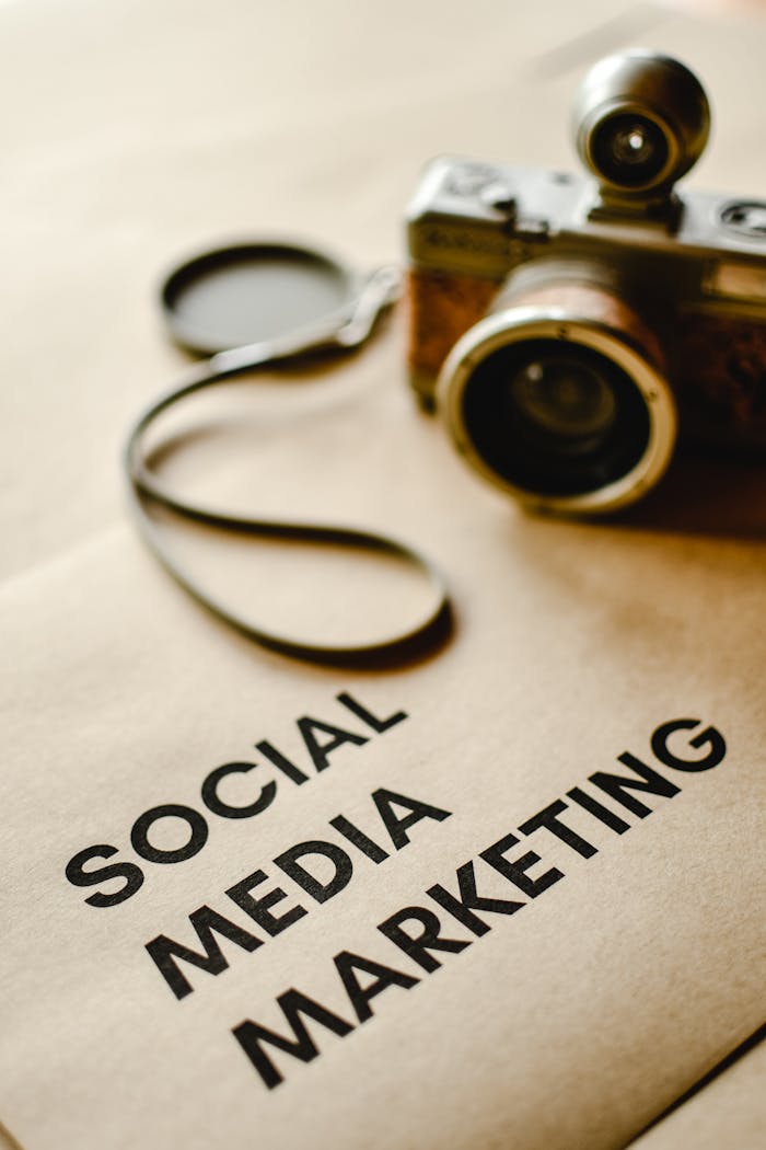 Close-up of a vintage camera on brown paper labeled with Social Media Marketing.